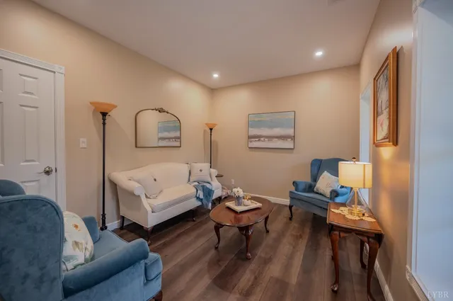 a view of a livingroom with wooden floor and a flat screen tv