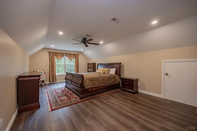 a view of backyard with a table and chairs and potted plants