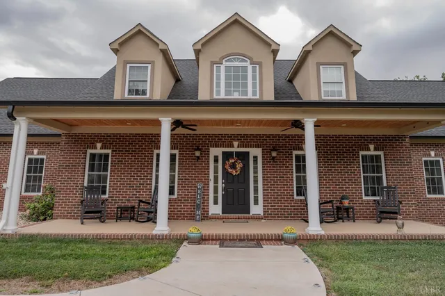 a backyard of a house with barbeque oven table and chairs