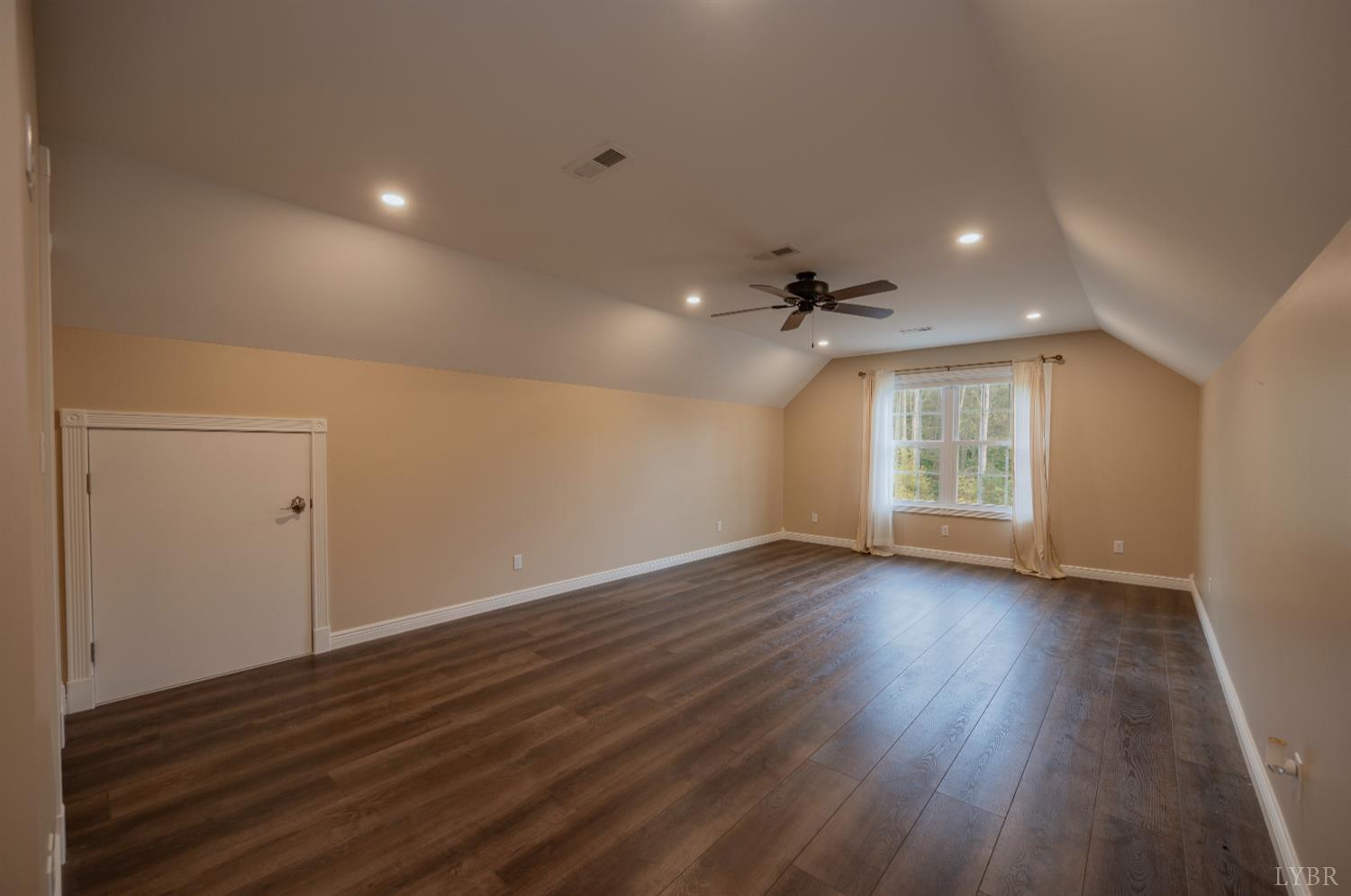 1080 Tranquility Lane Goode, VA 24556 - Photo 59 of 65 a view of an empty room with wooden floor and a window