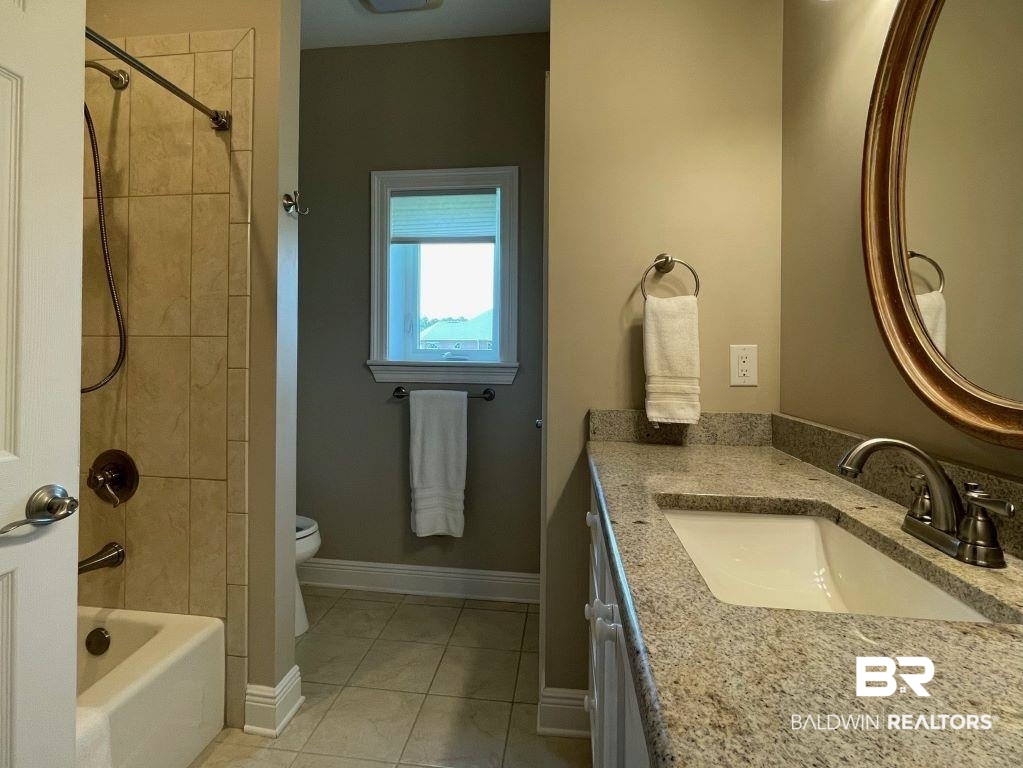6426 East Quarry Drive Elberta, AL 36530 - Photo 13 of 19 Full bathroom featuring vanity, tiled shower / bath combo, toilet, and tile patterned floors