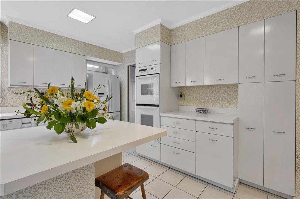 1080 Stanford Road Pittsburgh, PA 15205 - Photo 11 of 24 a kitchen with stainless steel appliances white cabinets and a potted plant
