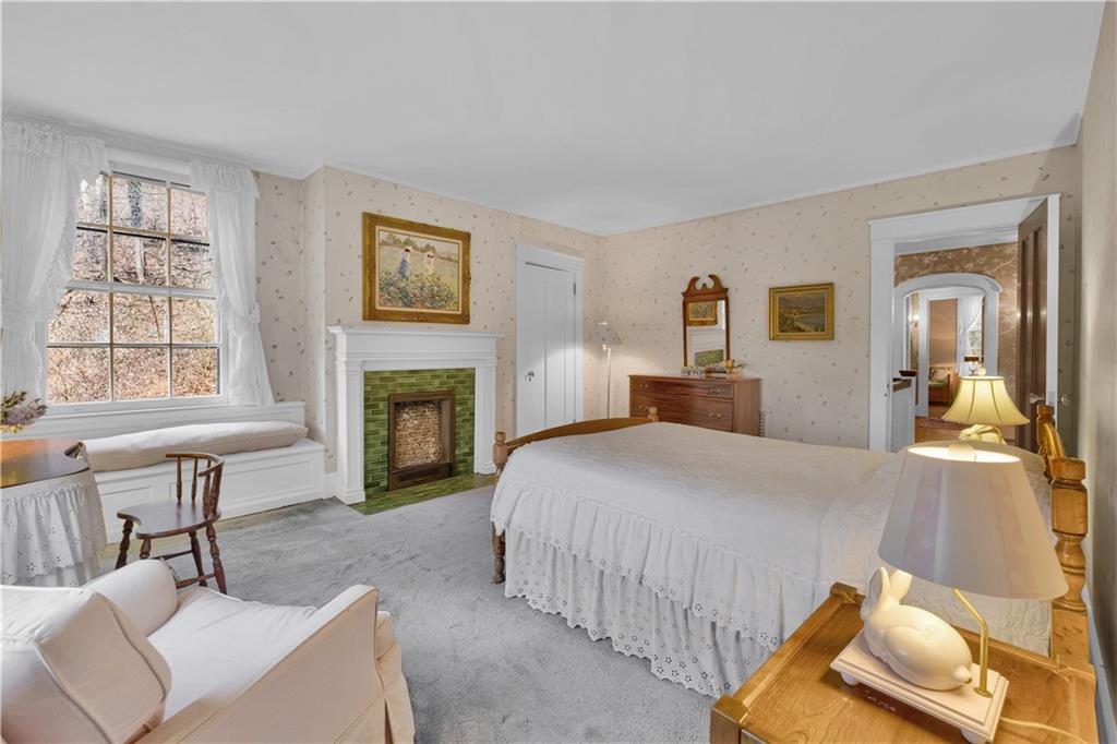 1080 Stanford Road Pittsburgh, PA 15205 - Photo 15 of 24 a bedroom with a bed and a fireplace