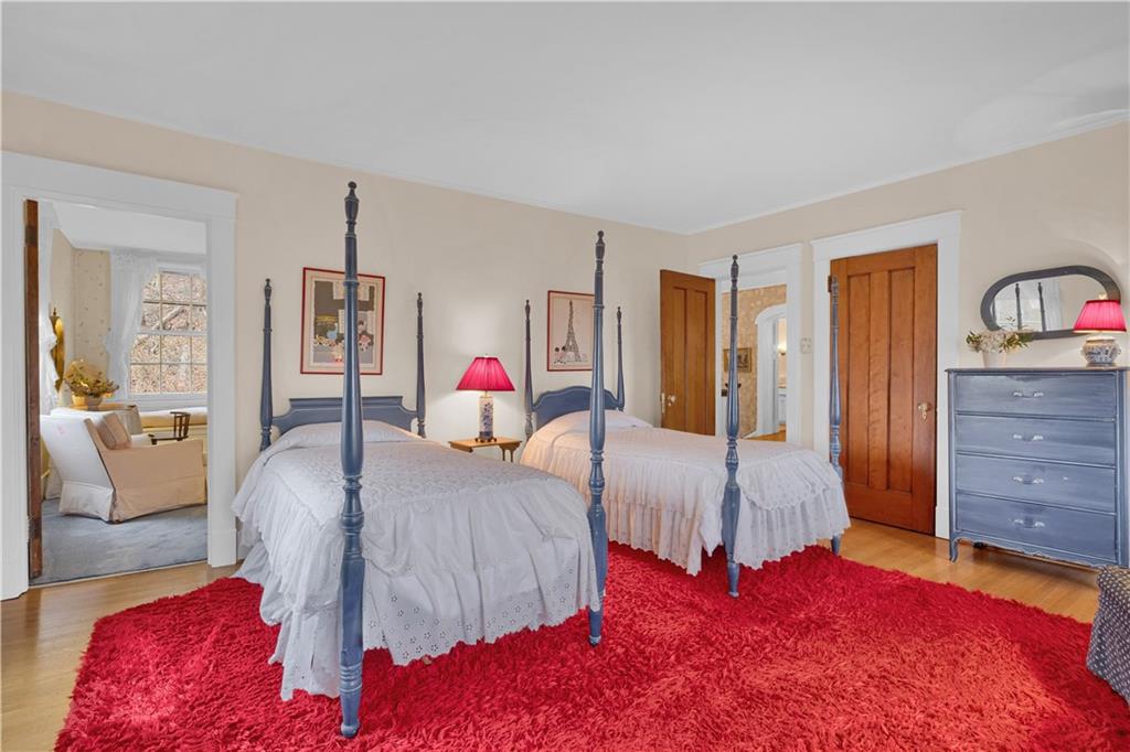 1080 Stanford Road Pittsburgh, PA 15205 - Photo 17 of 24 a bedroom with a bed and dresser with mirror