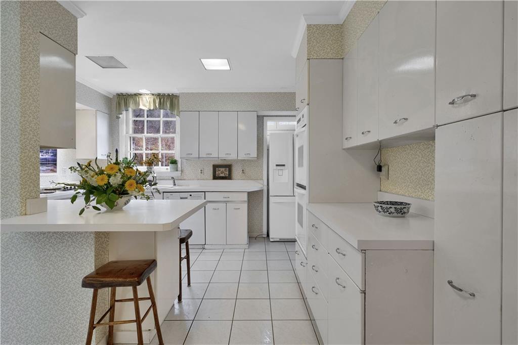 1080 Stanford Road Pittsburgh, PA 15205 - Photo 10 of 24 a kitchen with cabinets and chairs