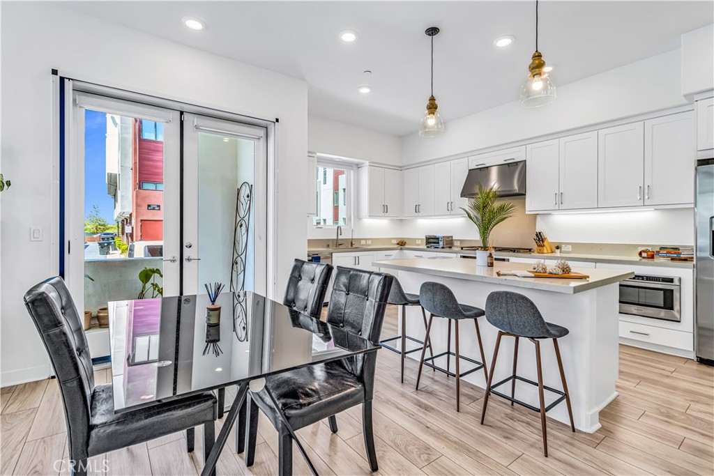 202 Waypoint Tustin, CA 92782 - Photo 12 of 46 a view of a dining room with furniture and wooden floor