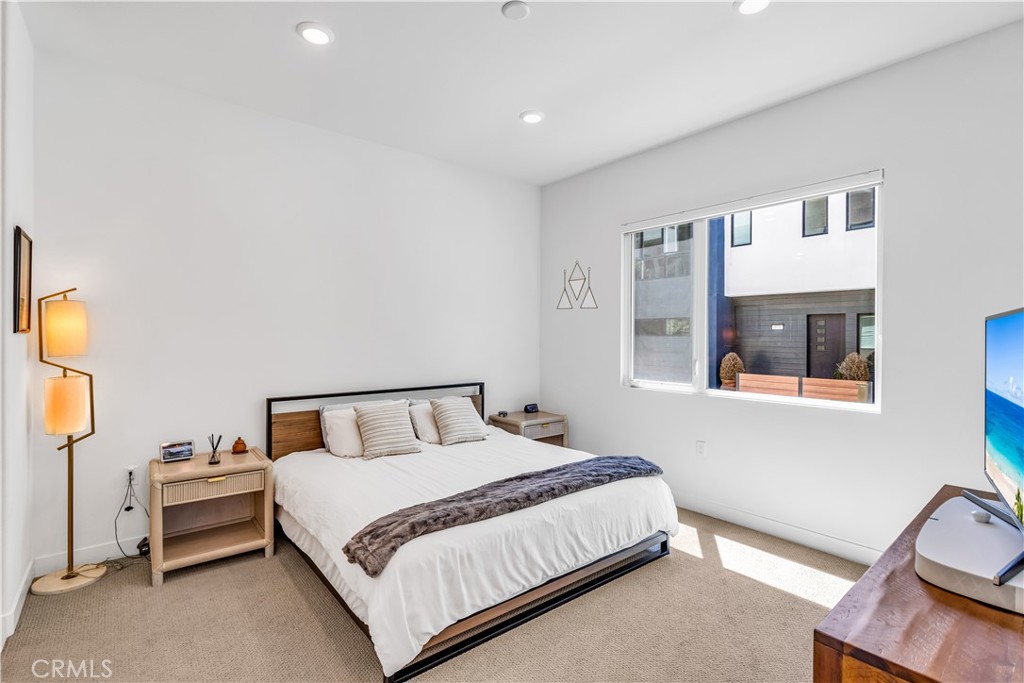 202 Waypoint Tustin, CA 92782 - Photo 21 of 46 a bedroom with a bed and lamp next to a window