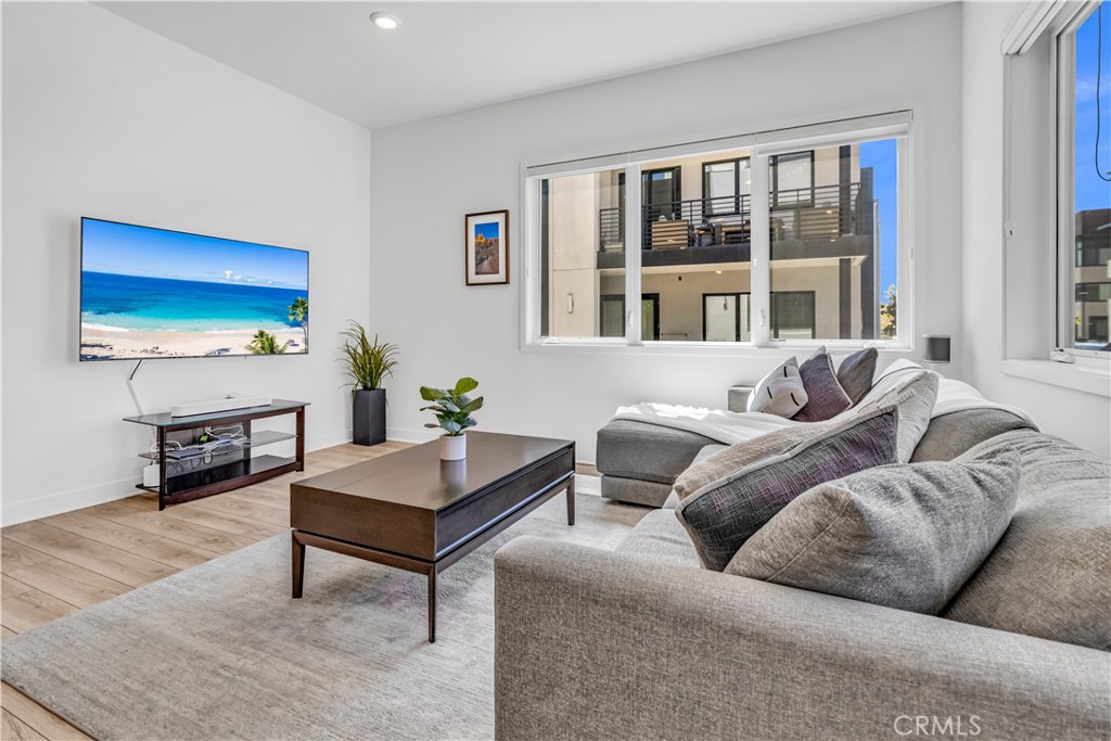 202 Waypoint Tustin, CA 92782 - Photo 10 of 46 a living room with furniture tv and a window