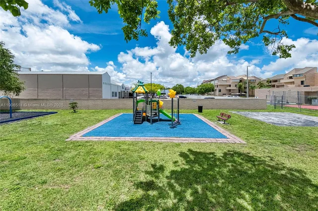 a view of a park with swings and slides
