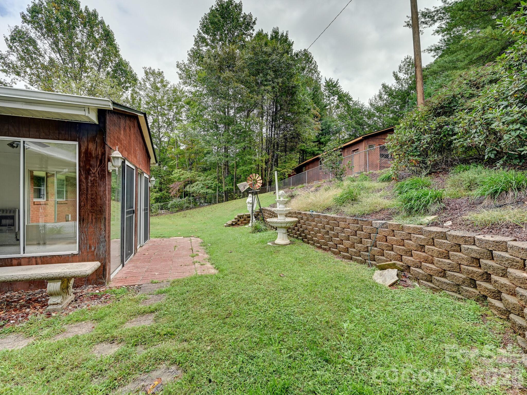 651 Case Cove Road Candler, NC 28715 - Photo 21 of 45 a backyard of a house with lots of green space