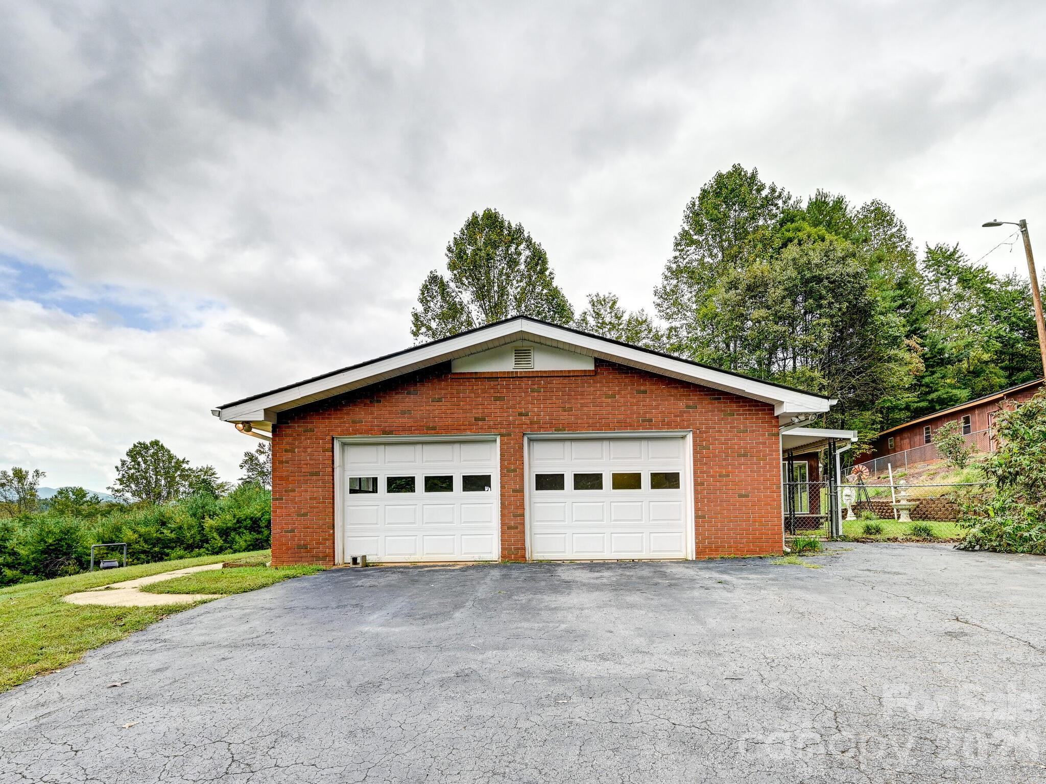 651 Case Cove Road Candler, NC 28715 - Photo 23 of 45 a view of a house with a yard and garage