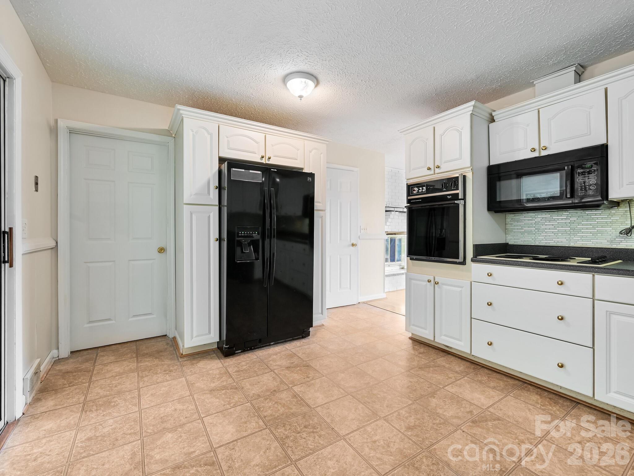 651 Case Cove Road Candler, NC 28715 - Photo 8 of 45 a kitchen with stainless steel appliances a refrigerator and microwave