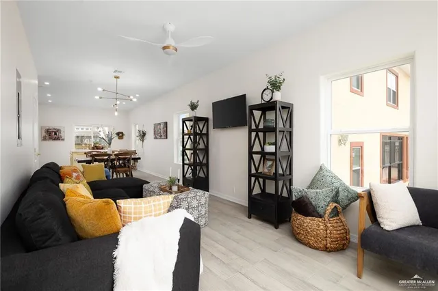 a living room with furniture and wooden floor