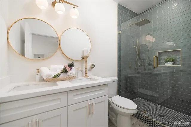 a bathroom with a toilet a sink and mirror
