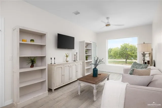 a living room with furniture window and a flat screen tv