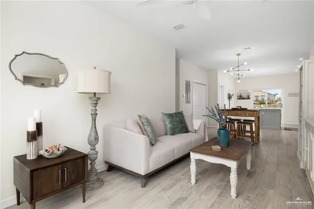 a living room with furniture and a mirror