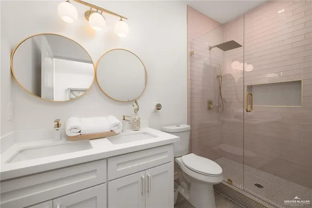 a bathroom with a toilet a sink and mirror