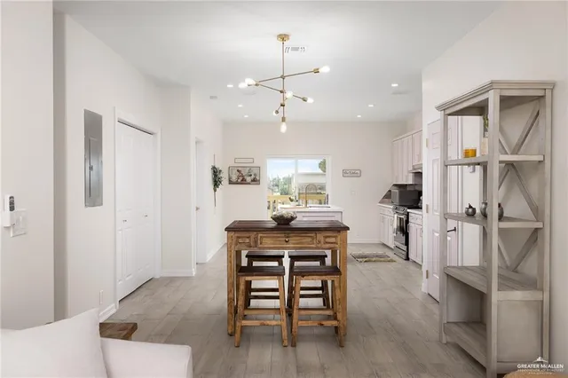 a view of a a dining room with furniture window and wooden floor