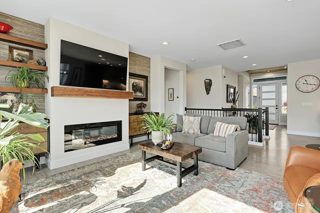 a living room with furniture fireplace and flat screen tv