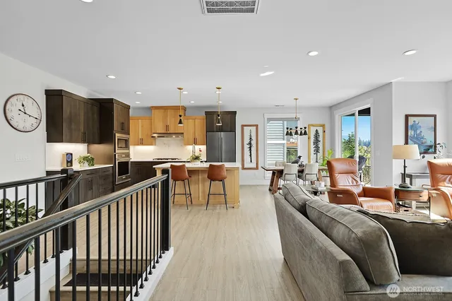 a living room with lots of furniture and kitchen view