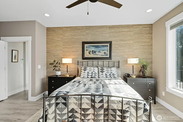 a large bedroom with bed and a night stand