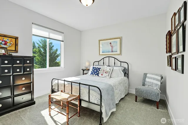 a bedroom with a bed a couch and a window