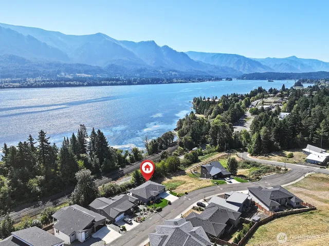 a view of a terrace with a table and chairs under an umbrella