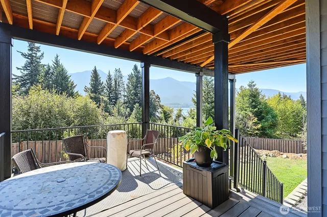 a view of a chair and tables in the balcony