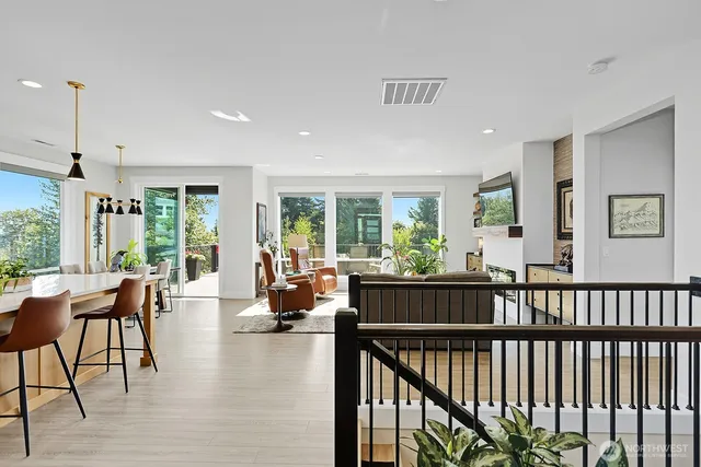 a living room with furniture and floor to ceiling windows
