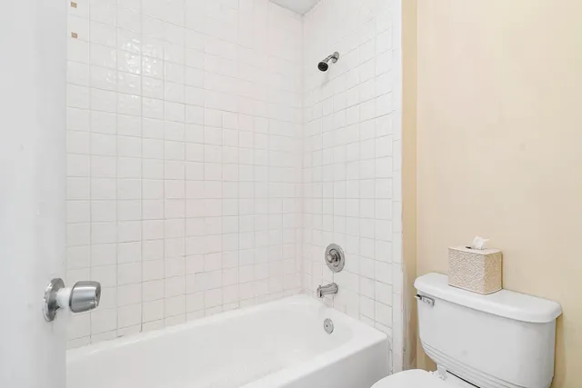 a bathroom with a bathtub and a toilet