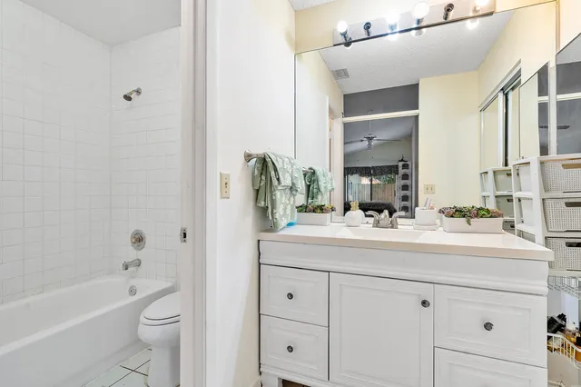 a bathroom with a double vanity sink toilet mirror and bathtub