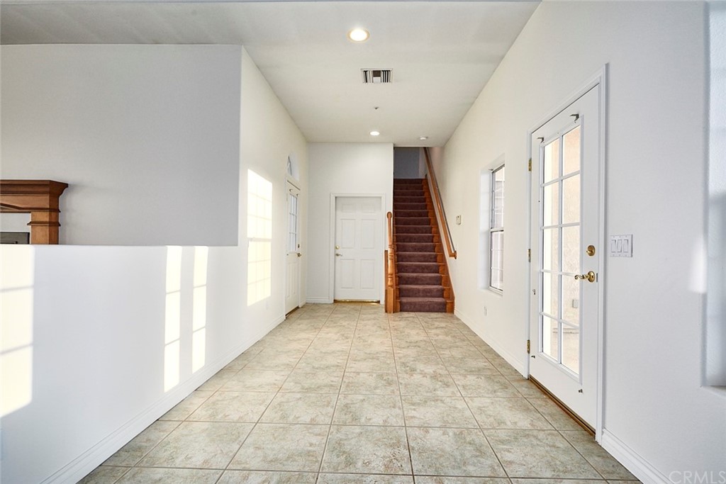 8250 Cataba Road Oak Hills, CA 92344 - Photo 11 of 53 a view of a hallway with wooden floor and staircase