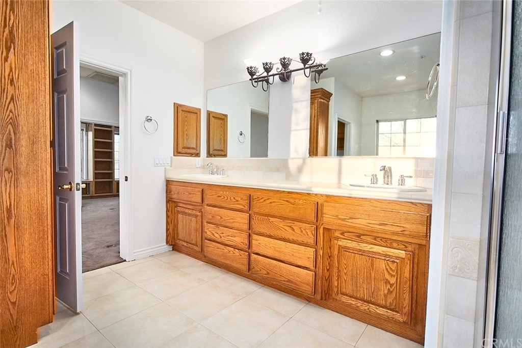 8250 Cataba Road Oak Hills, CA 92344 - Photo 29 of 53 a bathroom with a granite countertop sink mirror and