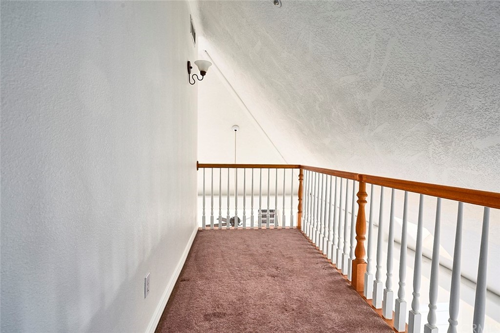 8250 Cataba Road Oak Hills, CA 92344 - Photo 38 of 53 a view of a hallway with wooden floor and stairs