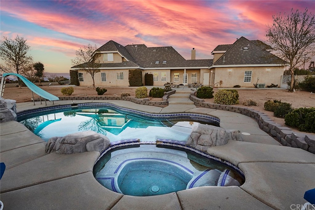 8250 Cataba Road Oak Hills, CA 92344 - Photo 9 of 53 a view of a white house with a swimming pool