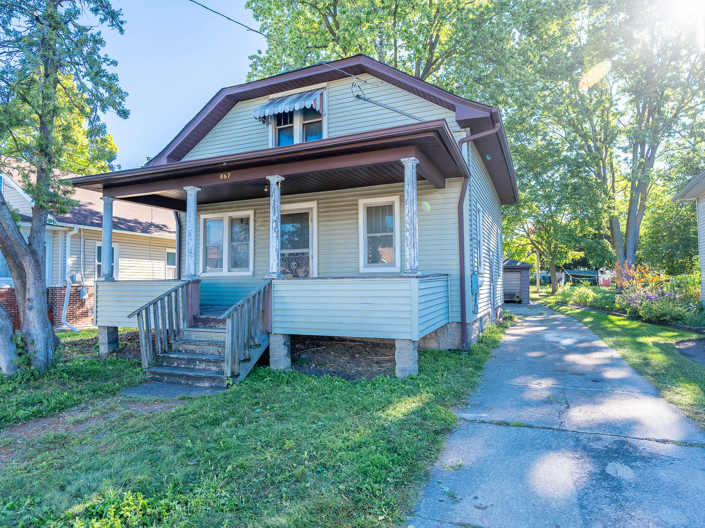 a view of a house with a yard chairs and a yard