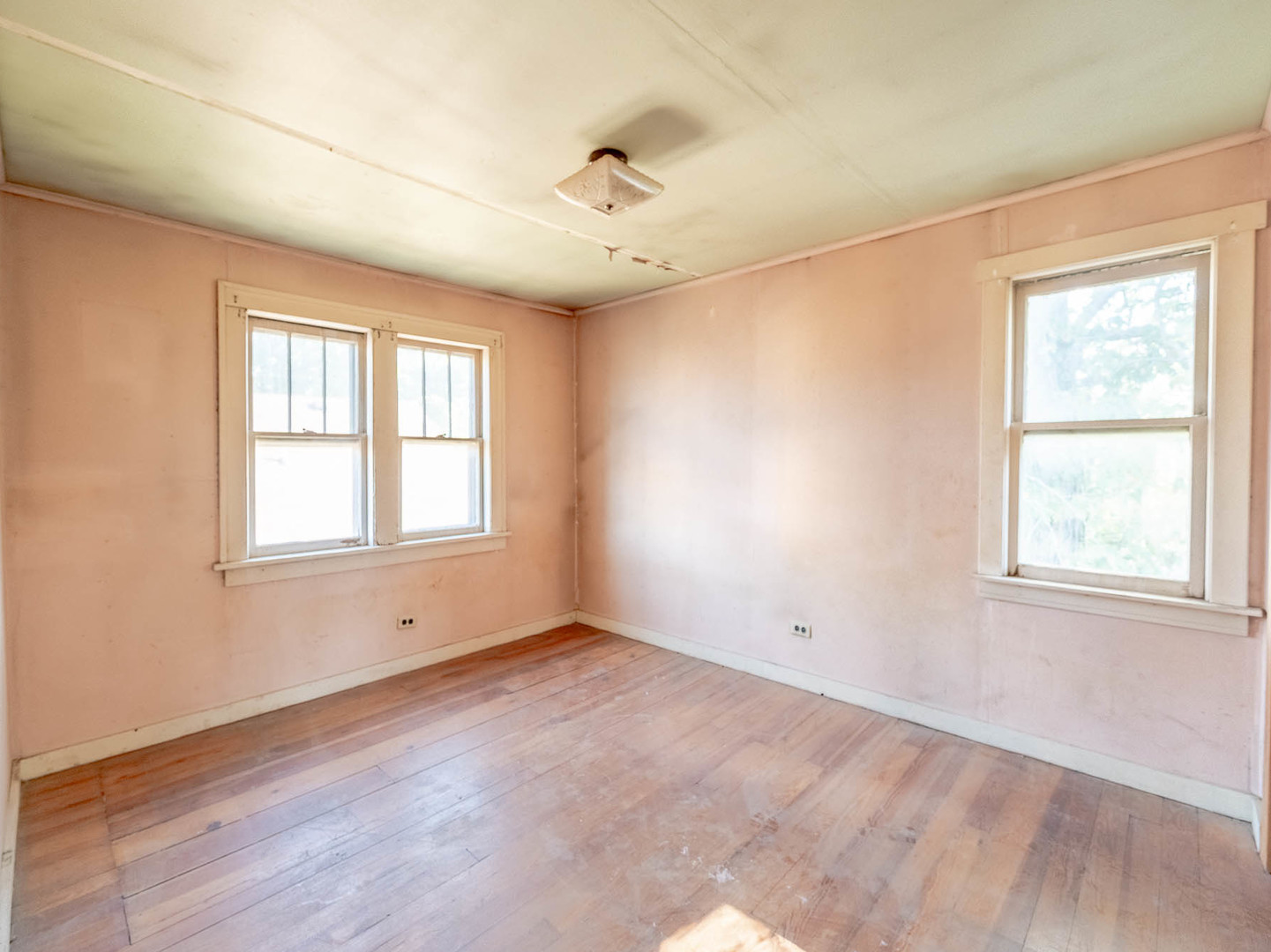 867 Church Road Aurora, IL 60505 - Photo 9 of 12 a view of an empty room with a window and wooden floor