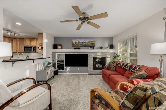 a living room with furniture and a fireplace