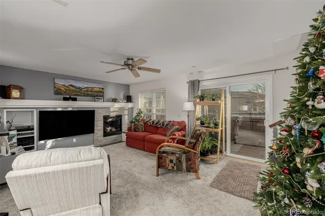 a living room with furniture a fireplace and a potted plants