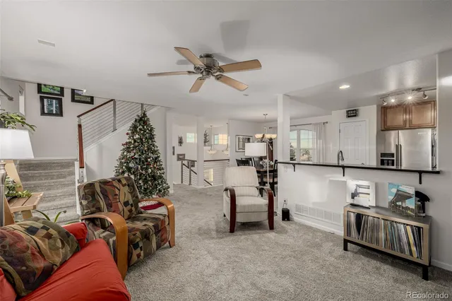a living room with furniture and kitchen view