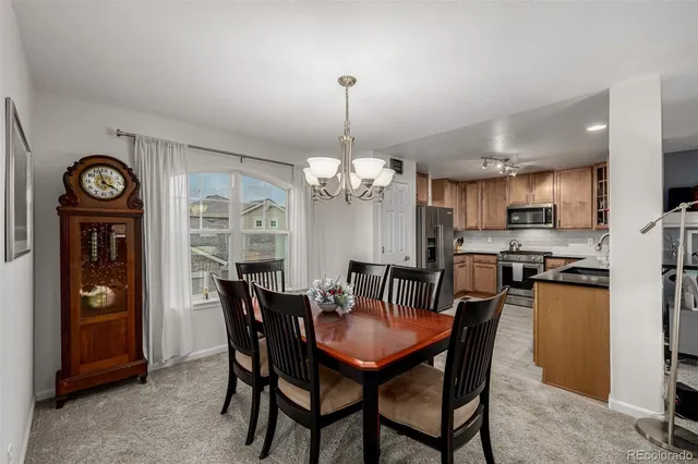 a view of a dining room with furniture wooden floor and a chandelier