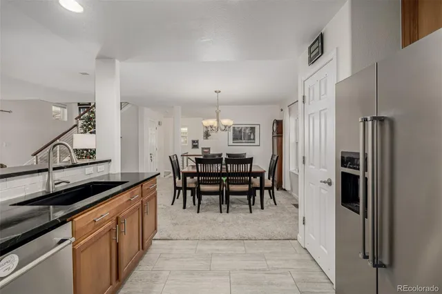 a kitchen with granite countertop cabinets and refrigerator