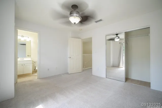 a view of an empty room and a bathroom