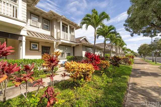 a front view of a house with a yard and flowers