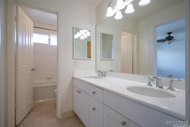 a bathroom with a sink a light fixture and a mirror