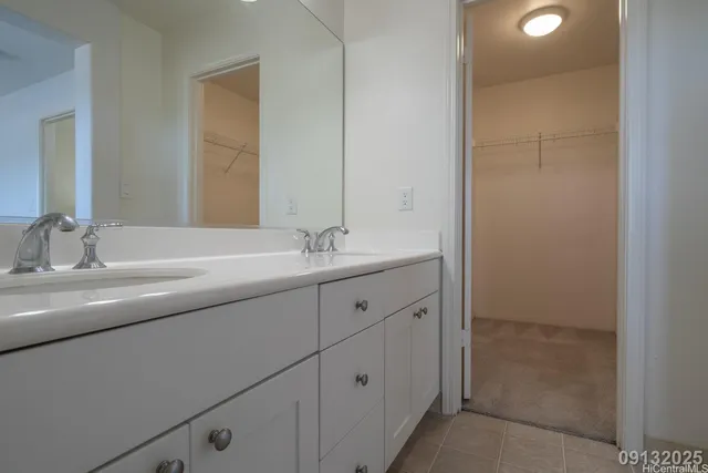 a bathroom with a double vanity sink and mirror