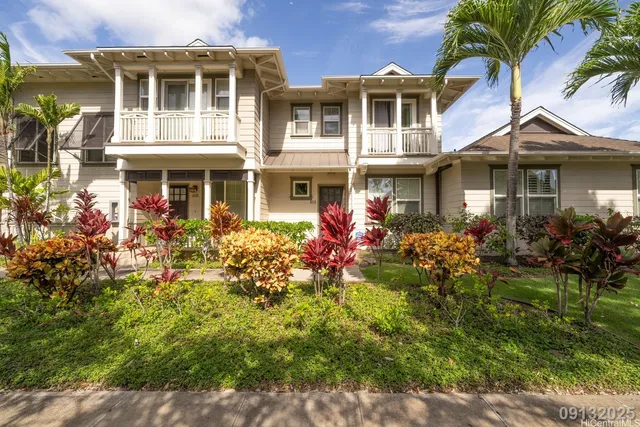 a front view of a house with a yard and fountain