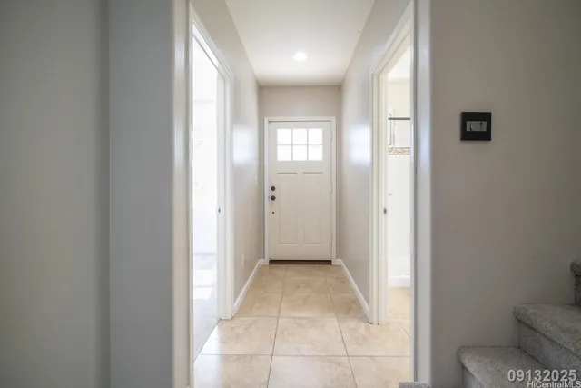 a view of a hallway with toilet and a window