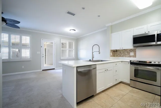 a kitchen with granite countertop a sink and stainless steel appliances