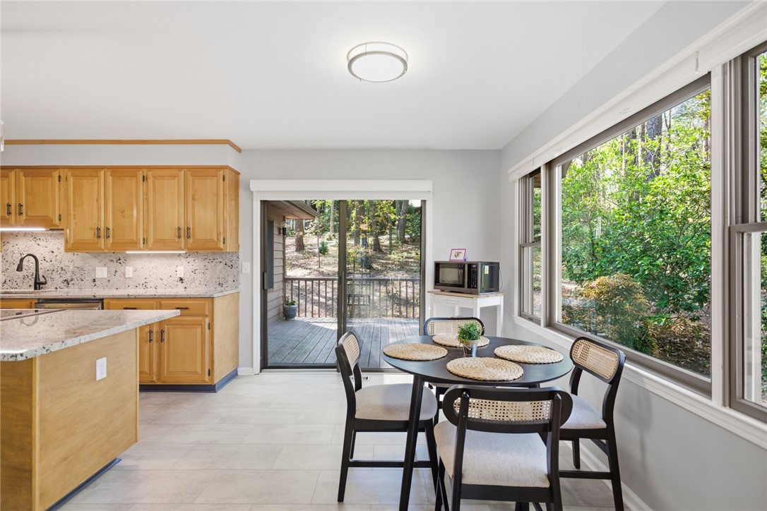 9 Tradewinds Way Salem, SC 29676 - Photo 12 of 45 This bright kitchen and dining area offers serene views of the surrounding natural landscape.